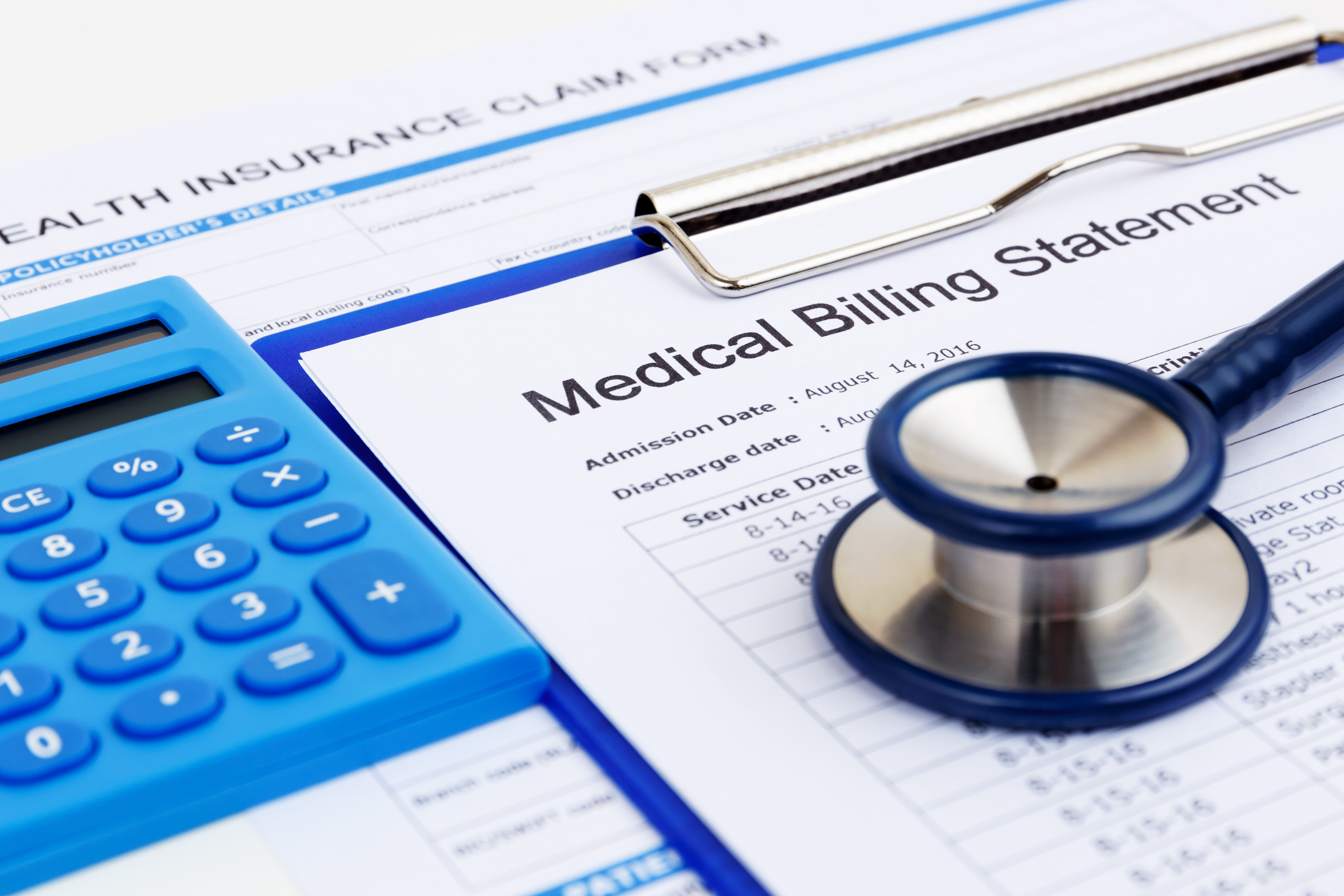 Medical bill and insurance form with calculator and stethoscope